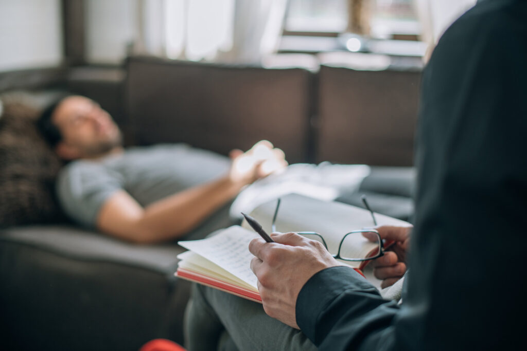 Hypnotherapist with a Client on a Sofa