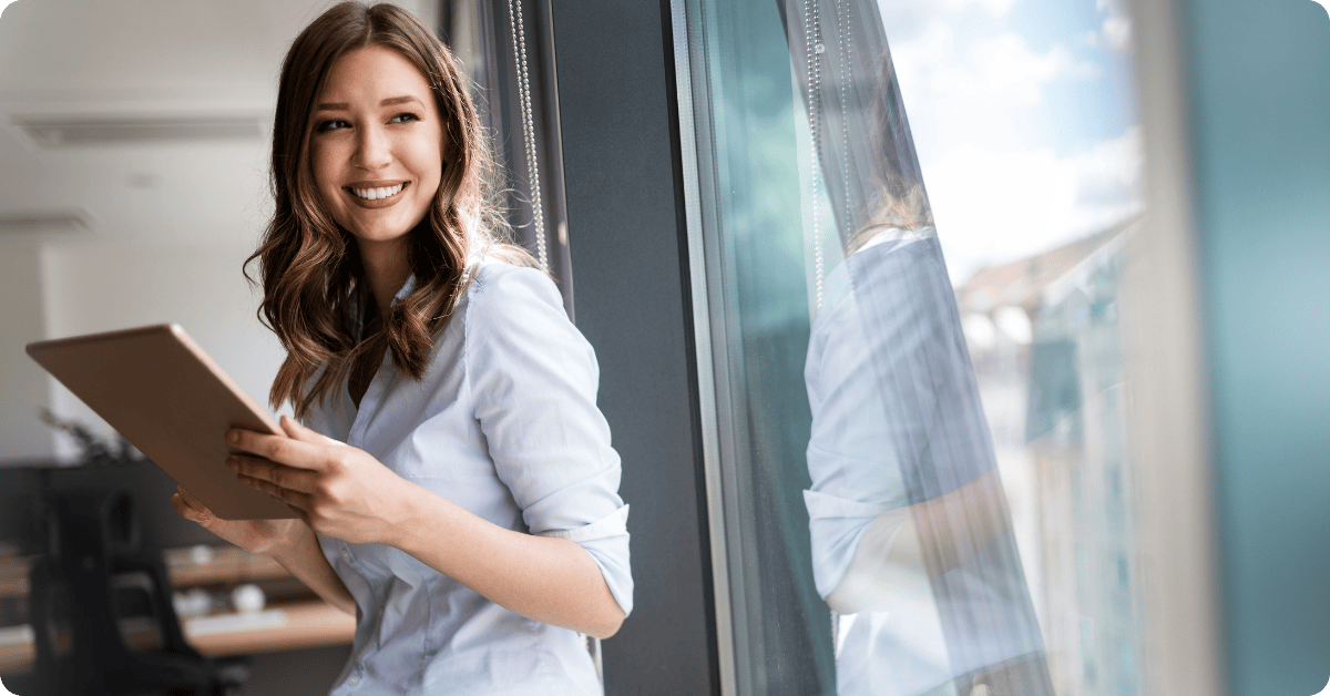 A Professional Woman Standing in Front of a Window